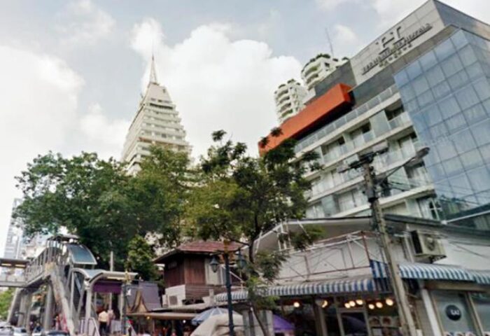 Street view of The Heritage Silom Hotel, a gay-friendly hotel in Bangkok, Thailand. Architecture and city life in Silom district.