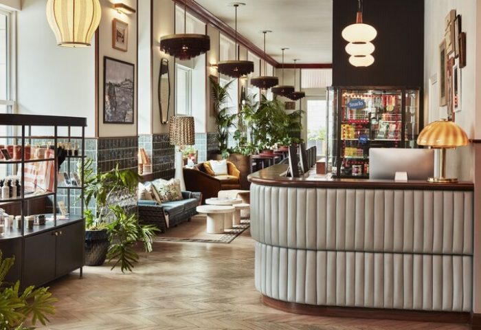 The Hoxton Downtown LA: Stylish lobby of this gay-friendly hotel. Check-in desk, seating area, plants, and modern decor create a welcoming vibe.
