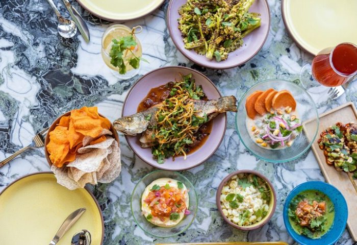 The Hoxton Downtown LA: Delicious food spread at this gay-friendly hotel. Fresh fish, chips, salads, and drinks on a marble table.