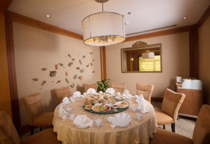 The Imperial Mae Ping Hotel's dining room. Round table set for a meal. Gay-friendly hotel in Chiang Mai, Thailand.