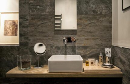 The Independent Suites gay-friendly hotel: bathroom sink, mirror, and toiletries. Modern design for gay men travelers.