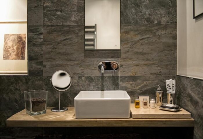 The Independent Suites gay-friendly hotel: bathroom sink, mirror, and toiletries. Modern design for gay men travelers.