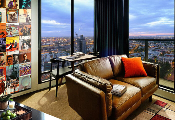 The Jazz Corner Hotel: Gay-friendly hotel room with leather couch, city view, and jazz-themed decor. A stylish stay for gay travelers.