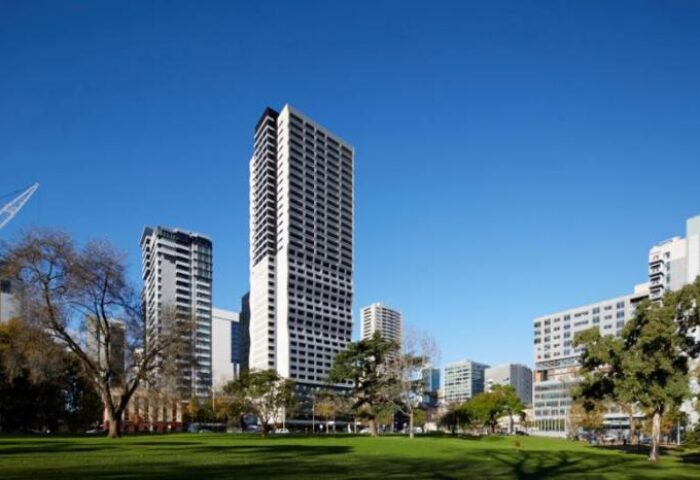 The Jazz Corner Hotel, a gay-friendly hotel. Tall building with a park in front of it. Great place for gay men to visit.