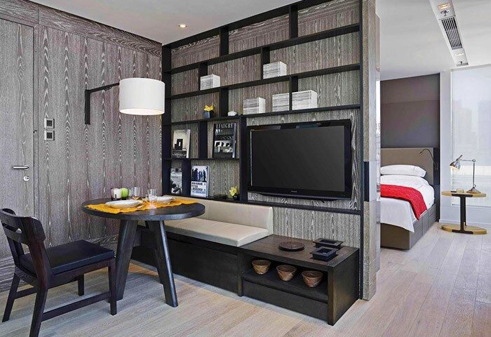 The Jervois hotel room. Gay-friendly hotel with living area, round table, and bed. Stylish interior design for gay travelers.