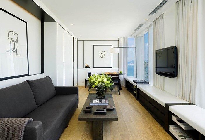 The Jervois hotel room. Modern interior, sofa, art, and window view. Gay-friendly hotel, stylish design for discerning travelers.