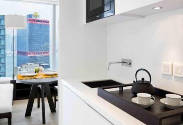 The Jervois, a gay-friendly hotel: Modern kitchenette with tea set, sink, and microwave. Table set for two with a city view.