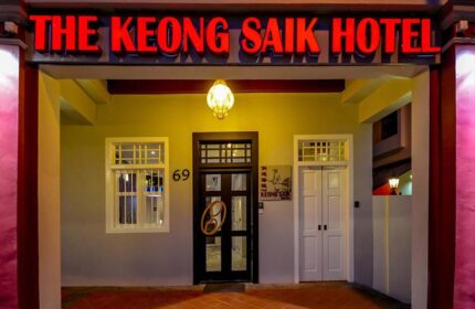 The Keong Saik Hotel facade. Gay-friendly hotel with red neon sign. Boutique hotel in Singapore for gay men travelers. Unique door handle.