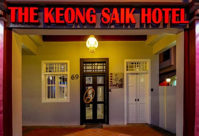 The Keong Saik Hotel facade. Gay-friendly hotel with red neon sign. Boutique hotel in Singapore for gay men travelers. Unique door handle.