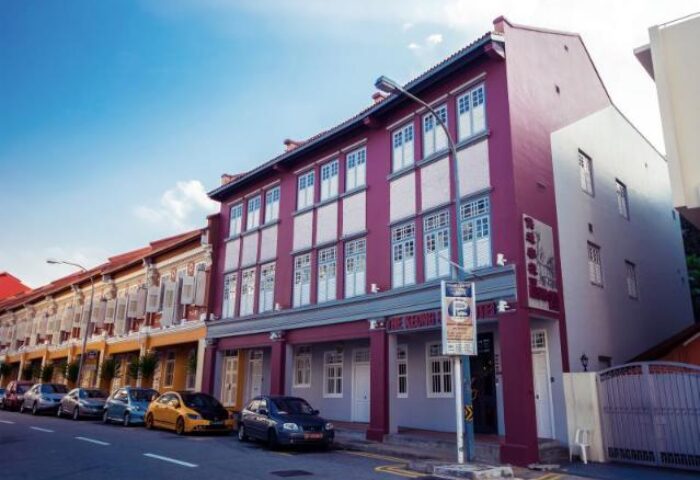 The Keong Saik Hotel exterior. Gay-friendly hotel in Singapore with colorful facade and street view. Boutique lodging for gay men travelers.