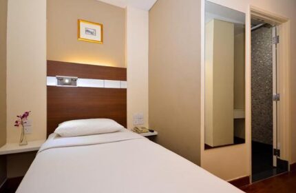 The Keong Saik Hotel room. Gay-friendly hotel with single bed, bathroom, and minimalist decor. Ideal for gay men travel in Singapore.