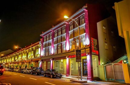 The Keong Saik Hotel's facade at night. This gay-friendly hotel in Singapore features a vibrant, colorful exterior and is a great choice for gay travel.