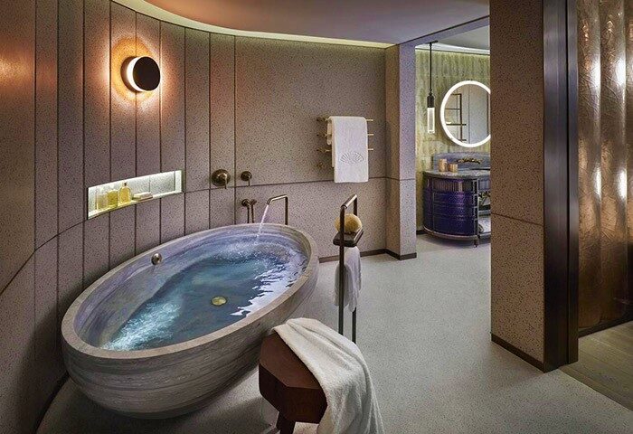 Luxurious bathroom at The Landmark Mandarin Oriental, Hong Kong. A gay-friendly hotel with a stylish oval tub and modern design.