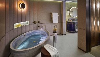 Luxurious bathroom at The Landmark Mandarin Oriental, Hong Kong. A gay-friendly hotel with a stylish oval tub and modern design.