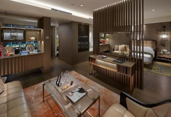 The Landmark Mandarin Oriental Hong Kong: Gay-friendly hotel suite. Modern design, living area, bar, and bedroom. Luxury travel for gay men.