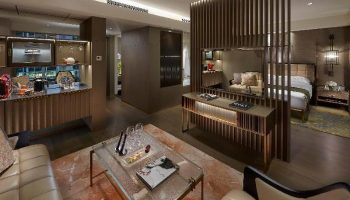The Landmark Mandarin Oriental Hong Kong: Gay-friendly hotel suite. Modern design, living area, bar, and bedroom. Luxury travel for gay men.