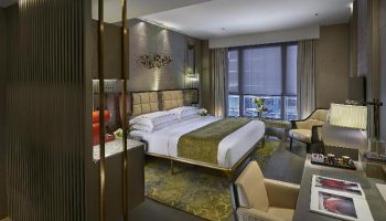 The Landmark Mandarin Oriental Hong Kong gay-friendly hotel room. Luxury suite with king bed, desk, city view. Perfect for gay travel.