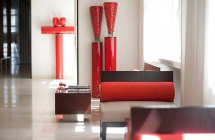 Lobby interior at The Levante Parliament, a gay-friendly design hotel. Adults-only space with red accents and modern furniture.