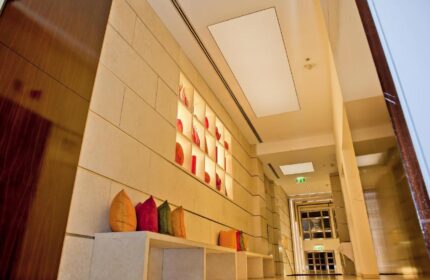 Hallway at The Levante Parliament, a gay-friendly design hotel in Vienna. Adults-only hotel interior with pillows and wall art.