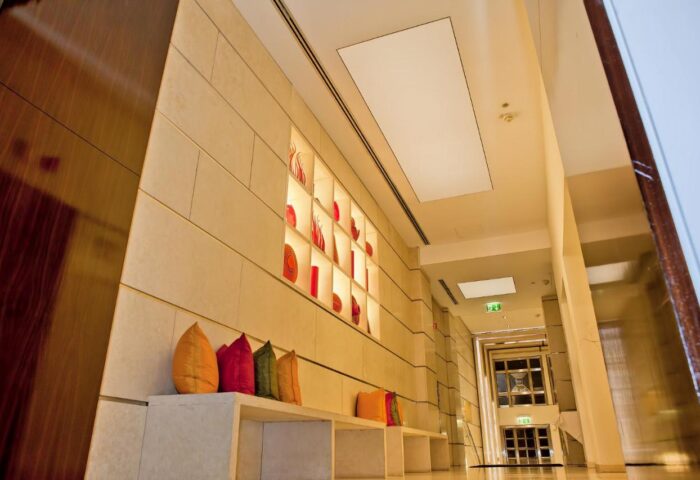 Hallway at The Levante Parliament, a gay-friendly design hotel in Vienna. Adults-only hotel interior with pillows and wall art.