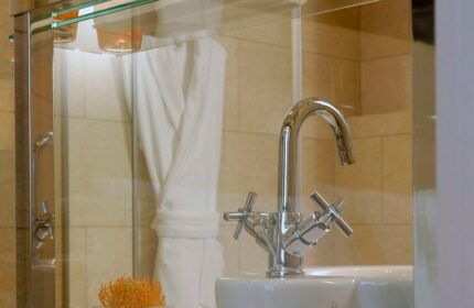Bathroom detail at The Levante Parliament, a gay-friendly design hotel. Chrome faucet, white sink, and modern decor. Adults Only hotel.