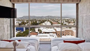 Gay-friendly The Linq Hotel and Casino room view. Two beds face a large window overlooking the city. Great for gay travel advice.