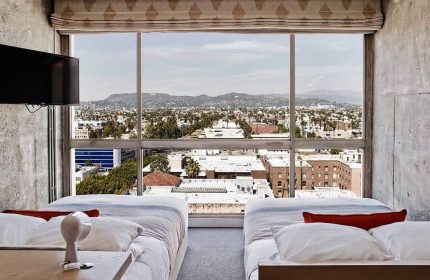Gay-friendly The Linq Hotel and Casino room view. Two beds face a large window overlooking the city. Great for gay travel advice.