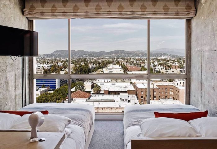 Gay-friendly The Linq Hotel and Casino room view. Two beds face a large window overlooking the city. Great for gay travel advice.