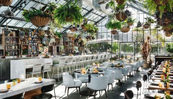 Gay-Friendly The Linq Hotel and Casino restaurant. Interior with plants, bar, tables and chairs. Great spot for gay travelers.