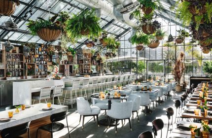 Gay-Friendly The Linq Hotel and Casino restaurant. Interior with plants, bar, tables and chairs. Great spot for gay travelers.