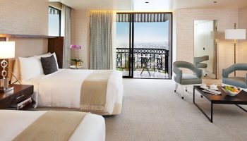 The London West Hollywood at Beverly Hills: luxurious room with balcony view. Gay-friendly hotel with modern design and comfortable seating area.