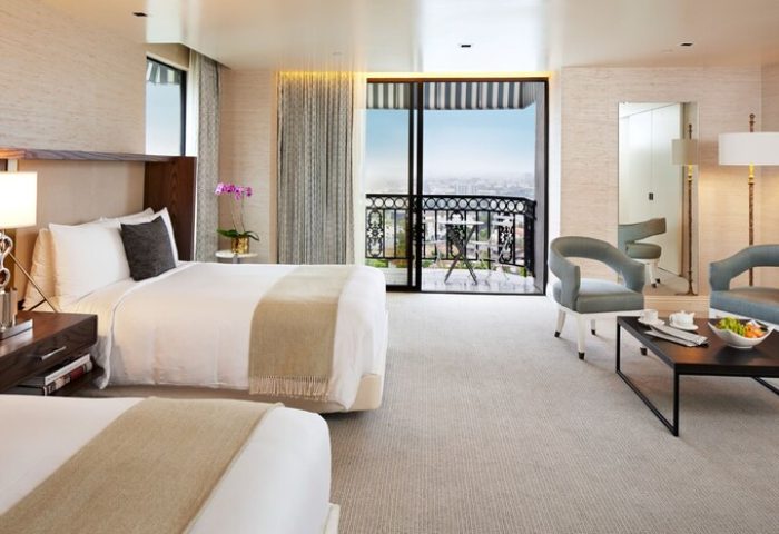 The London West Hollywood at Beverly Hills: luxurious room with balcony view. Gay-friendly hotel with modern design and comfortable seating area.
