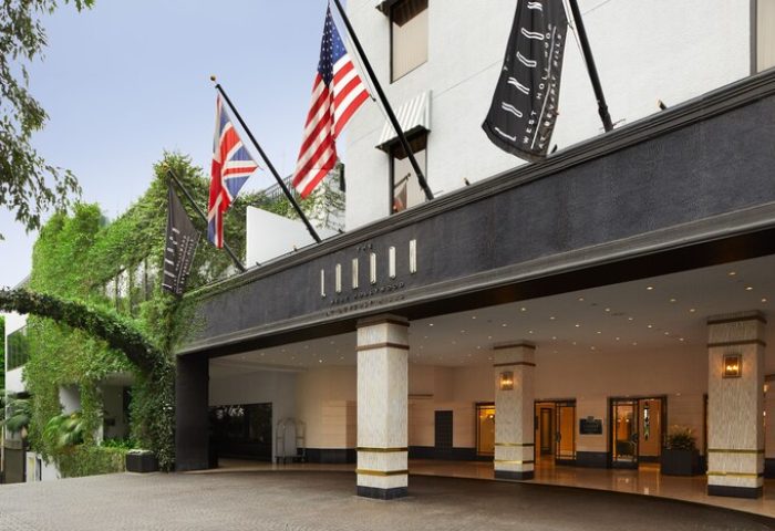 The London West Hollywood at Beverly Hills entrance. Gay-friendly hotel with flags. Luxury travel for gay men in West Hollywood, California.