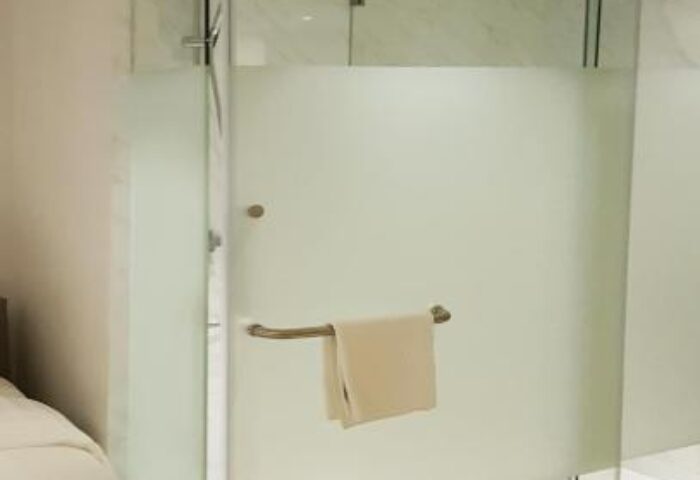 Shower at The Mini Suites Eton Tower Makati, a gay-friendly hotel. Clean glass, towel. Modern design for gay travelers.