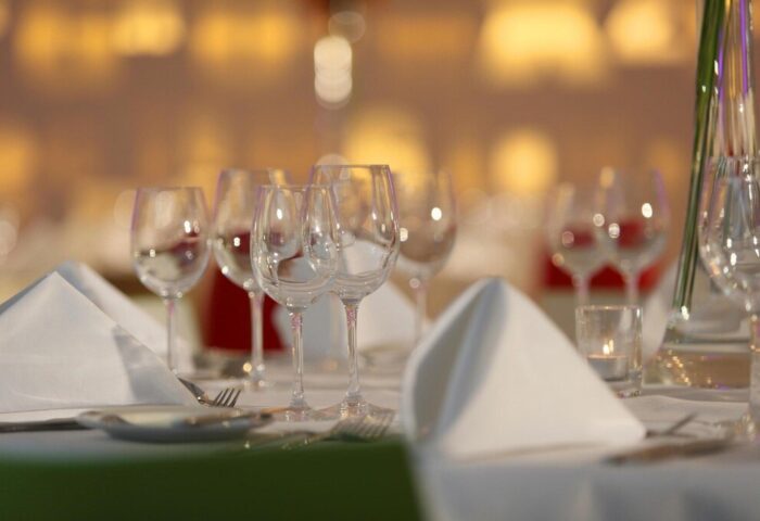Table setting at The Morrison, a DoubleTree by Hilton Hotel. Wine glasses, napkins, and silverware. Gay-friendly hotel dining.