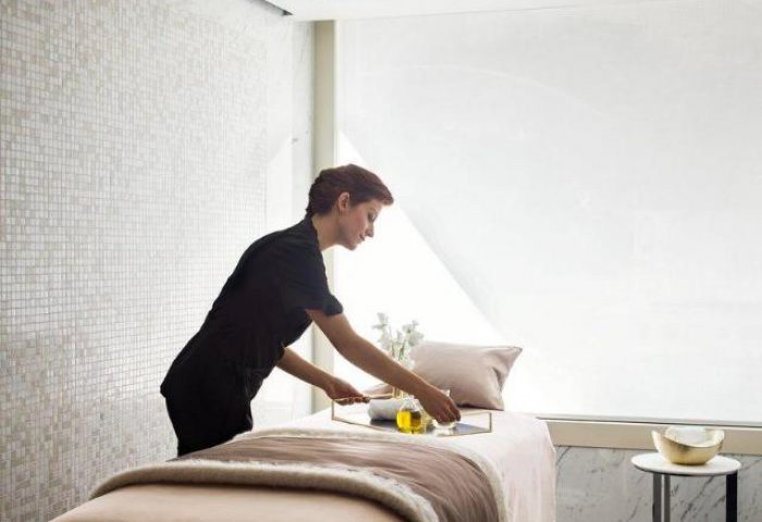 Spa treatment room at The Murray, Hong Kong, a Niccolo Hotel. A staff member prepares for a massage at this gay-friendly hotel.
