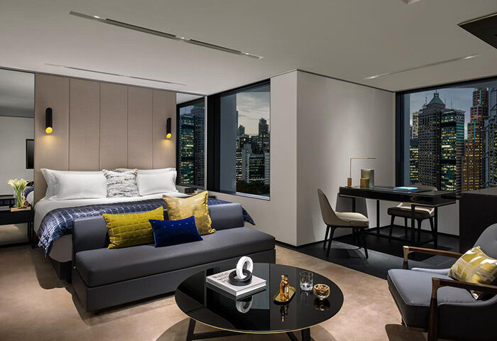 Hotel room at The Murray, Hong Kong, a Niccolo Hotel. Gay-friendly travel suite with skyline view, desk, seating area, and king-size bed.