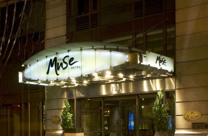 The Muse Hotel New York entrance at night. A gay-friendly hotel offering luxury accommodations in NYC for gay travelers.