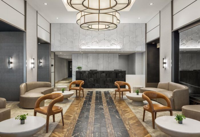 The Muse New York, a gay-friendly hotel. Lobby seating area with modern decor, stylish furniture, and a welcoming ambiance.