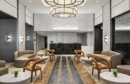 The Muse New York, a gay-friendly hotel. Lobby seating area with modern decor, stylish furniture, and a welcoming ambiance.