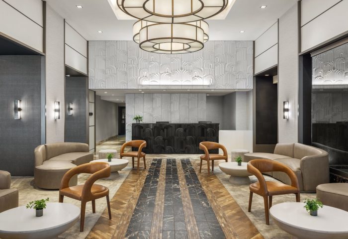 The Muse New York, a gay-friendly hotel. Lobby seating area with modern decor, stylish furniture, and a welcoming ambiance.