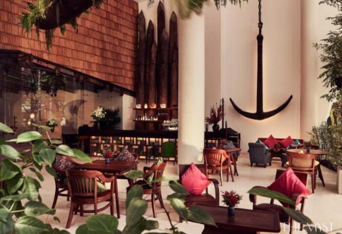 The Myst Dong Khoi gay-friendly hotel interior. Upscale bar, tables, chairs, anchor decor. A stylish choice for gay travelers.