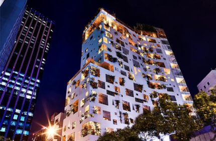The Myst Dong Khoi at night. Gay-friendly hotel with unique architecture, featuring plants in window boxes. A top destination for gay travel.