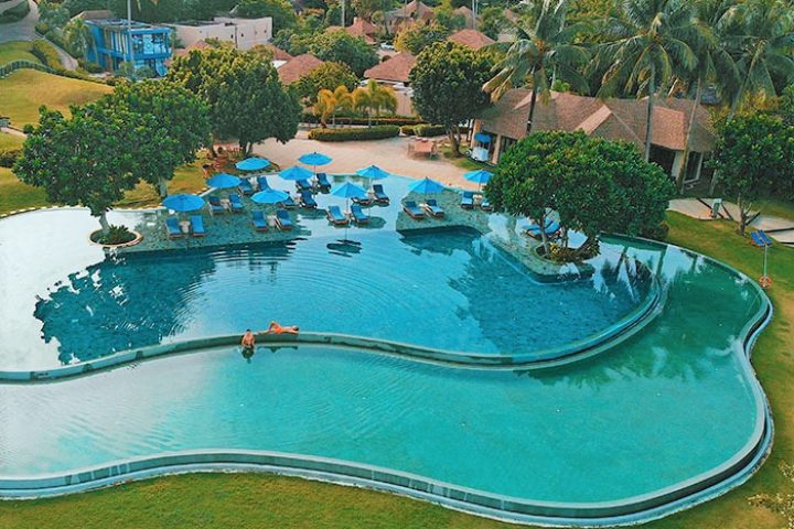 Aerial view of The Naka Island, a Luxury Collection Resort & Spa, Phuket. Gay-friendly hotel with a unique pool and tropical landscape.