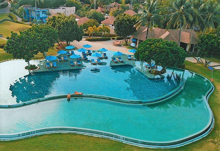 Aerial view of The Naka Island, a Luxury Collection Resort & Spa, Phuket. Gay-friendly hotel with a unique pool and tropical landscape.