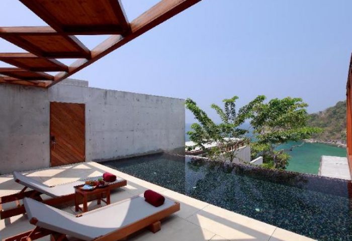 The Naka Phuket Villa's gay-friendly hotel. Luxury villa with pool, ocean view, and lounge chairs. A perfect gay travel destination.