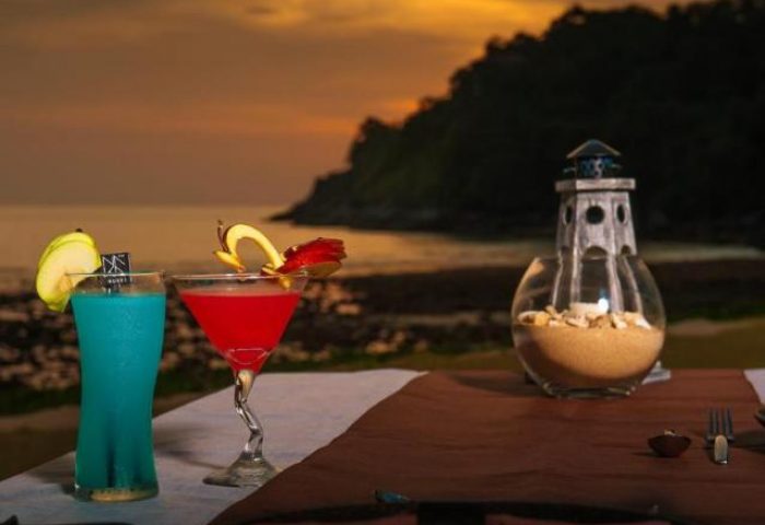 Sunset cocktails at The Naka Phuket Villa, a gay-friendly hotel. Enjoy drinks with an ocean view at this stunning Phuket villa.
