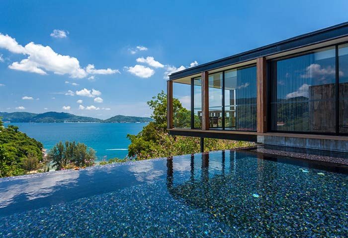 The Naka Phuket Villa's infinity pool overlooks the ocean. This gay-friendly hotel offers luxury villas with stunning views. Phuket travel.
