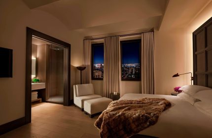 The New York EDITION hotel room. Gay-friendly hotel with city views, a plush bed, and a modern bathroom. Luxury travel for gay men.