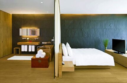 Hotel room at The Opposite House Hotel, a gay-friendly hotel. Modern design with a bed, bathroom, and TV. Perfect for gay travel.